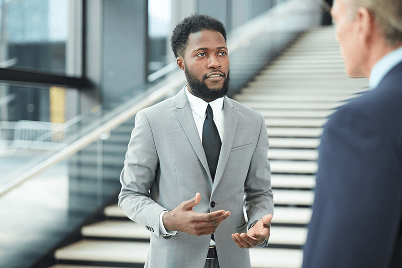 Young African American executive respectfully tells his boss no while still advancing his career