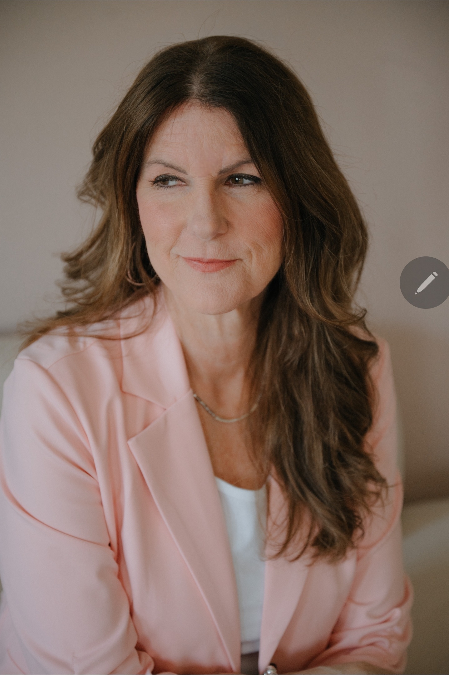 Erin Kennedy executive resume writer pink blazer close portrait